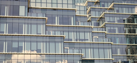 Glass building window. Architectural detail. Background of architecture. Modern glass background. Glass facade background. Architecture. Building facade geometric architecture. Building backgroundの写真素材