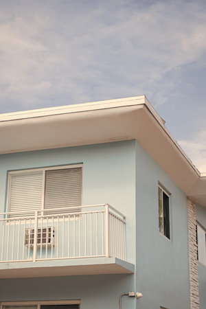 View of building facade. Residential building architecture. Architectural exterior. House exterior fragment. Modern apartment building facade. Apartment building with blue exterior detailの写真素材