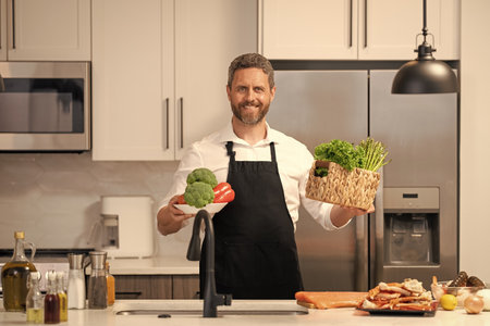 Home menu with fresh food ingredient. Man cook cooking at kitchen. Hispanic man standing in kitchen...