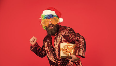 in a hurry. bearded hipster in xmas party glasses. man with beard in santa claus hat. winter holiday...