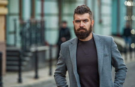 Businessman in the city. City street with business man. Man style fashion. Stylish and brutal man in...