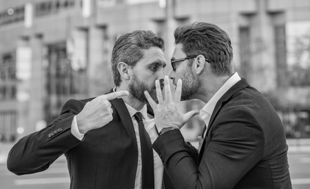 Business conflict. Two businessmen conflicting at fight outdoor. Businessmen having conflict in...
