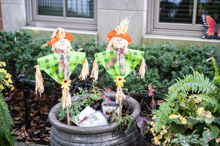 Garden scarecrow. Happy Halloween. Autumn Halloween decoration in countryside garden. Rural garden scarecrow decoration. Scarecrow in fall country gardenの写真素材
