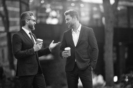 Businessman outdoor. Business man at coffee break. Businessman with coffee cup outdoor, copy space. Successful man after business meeting. Business of businessman. Coffee breakの写真素材