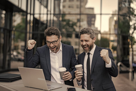 Online working. Businessmen checking email. Business men freelancing outdoor. Business online. Men...