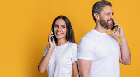Family couple talk on phone. Modern communication technology. Man and woman speak on phone. Family connected in distance. Couple having phone conversation. Distance relationship. Bannerの写真素材