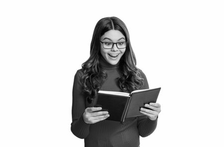 school girl reading her book. teen education through reading. book lover. back to school. teen school girl reading time. knowledge and education. inspiration in her readingの写真素材