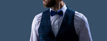 Man with bow tie isolated on grey. Stylish man in elegant black suit. Gentleman in tuxedo vest....