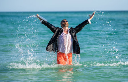 happy businessman in suit at sea. successful businessman on summer vacation. Summer business travel....