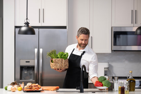 Home menu. Hispanic man cooking in kitchen. Healthy food for dinner. Man cooking home food. Healthy...