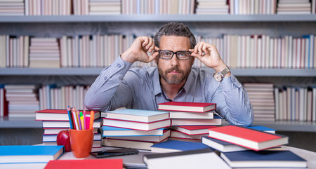 school teacher professor prepare for exam reading books getting knowledge and education at teachers...