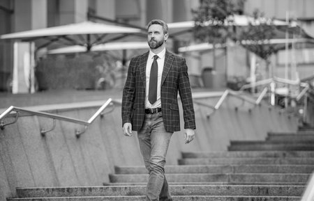 Business boss man. Wall street success. Successful business. Success of entrepreneur. Office manager man. Businessman walking in city. Businessman in suit. Mature businessman outdoor. Leadershipの写真素材