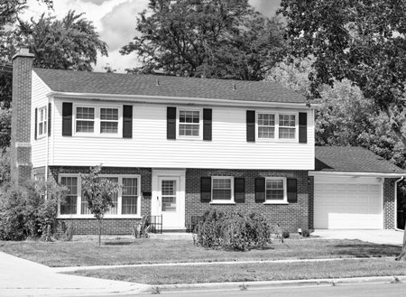 Suburb exterior with private housing. Suburban neighborhood. Private family home architecture. House exterior. Private house in suburban area. Suburban house architecture. Residential privacyの写真素材