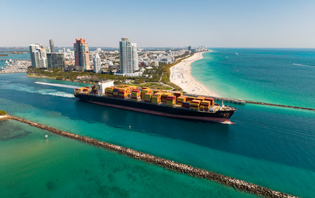 Shipping logistics. Commercial shipping. Top view. Cargo ship in sea, aerial view. Freight container loaded on cargo vessel. Aerial cargo ship with container. Cargo business. Container shipの写真素材