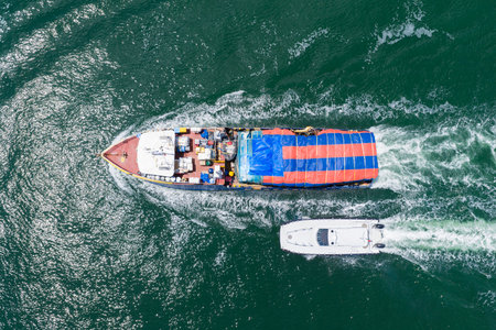 Shipping logistics. Commercial shipping. Top view. Cargo ship in sea, aerial view. Freight container...