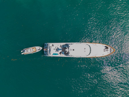 Vacation on summer. Summertime motorboat tour. Luxury motor boat yacht. Yacht go to marina. Boating and yachting. Luxury lifestyle. Marina yacht club aerial view. Yacht luxury view at seaの写真素材