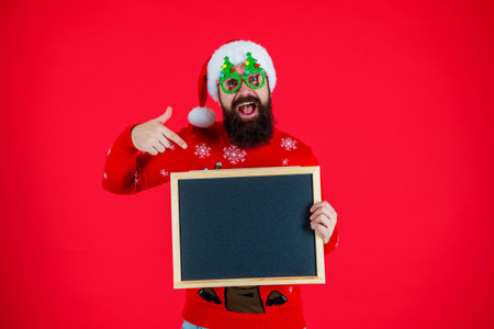 Winter shopping offer, copy space. Holiday sale. Advertisement of winter sale. Having fun. Christmas holiday and shopping. Santa man show advertisement. New Year man prepare for holidayの写真素材