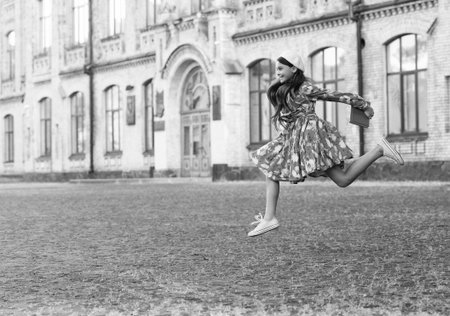 Teen girl jumping back to school. Knowledge day. Education in school. Girl student jump outdoor. September 1. Time to study. Knowledge and education. School education. Students life. Copy spaceの写真素材