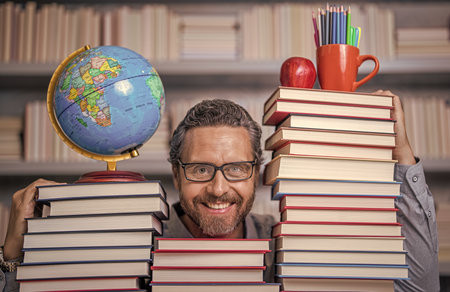 teachers and knowledge day. clever school teacher. bookworm man in classroom. school teacher with...