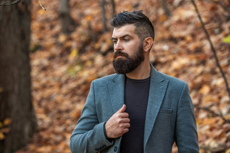 Bearded businessman outdoor. Bearded man wearing street style in autumn. Businessman in fall park....