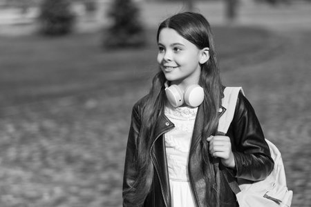 Teen girl school student outdoor. Copy space. Student life. Listen to music in headphones. Teen girl generation. Lifestyle and education. Back to school. School education. Adolescence lifestyleの写真素材