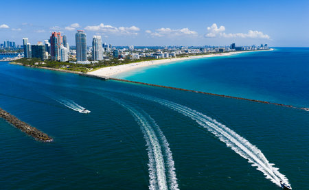 Luxury yacht cruising near Miami skyline. Aerial view of boats on turquoise waters in Miami. Yacht retreat in South Florida Miami. Miami cityscape with sailing vessels. Waterfront Miamis panorama.の写真素材