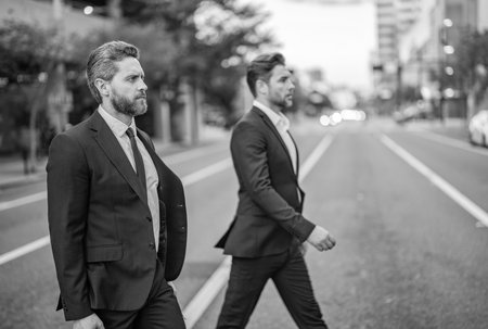 Businessmen in suit walk outdoor. Success. Walk to success. Two businessmen walk in the city....