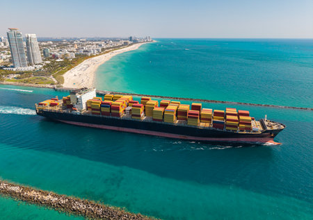 Cargo ship in sea, aerial view. Freight container loaded on cargo vessel. Aerial cargo ship with...