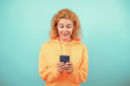 Woman use phone. Girl chatting in blog. Using phone in shopping. Woman work online. Millennial woman chatting online isolated on blue. Business chatting communication. Online shopping. Group chatの写真素材