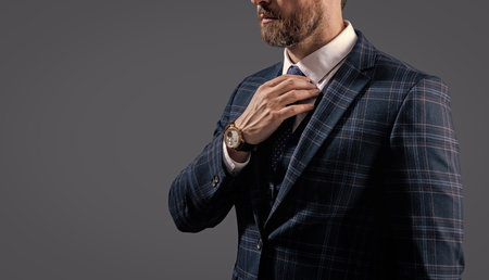 Time. Elegant businessman isolated on grey. Male accessory. Business man in tie show luxury watch....