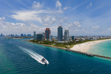 Aerial view of boats on turquoise waters in Miami. Yacht retreat in Miami. Oceanfront cityscape with sailing vessels in Miami. Relaxing vacation in Miami. Beautiful sunset over the coastal city.の写真素材