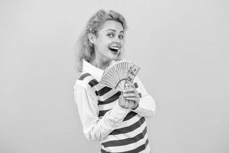 Profit growth. Businesswoman reinvest profit for growth. Businesswoman with money on yellow. Successful business woman. Profit margin. Profitable companies attract investors. Financial stabilityの写真素材