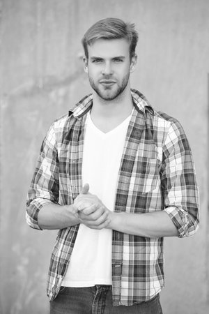 Handsome young man outdoor. Millennial man wearing checkered shirt. Casual style of millennial man. Portrait of man in casual style shirt. Stylish portrait of unshaven guy. Effortlessly stylishの写真素材