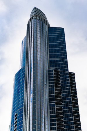 Architecture in business district. Building architecture. Business building. Glass building. Business city. City architecture. Modern glass building. Reflective glass architecture. Downtown hubの写真素材