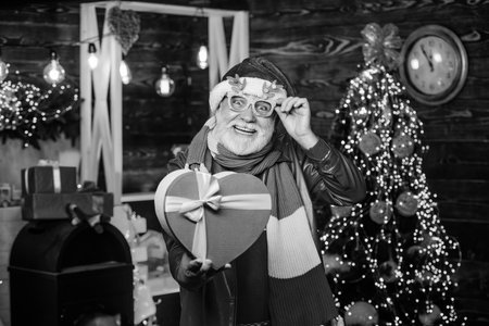 Christmas charity. Spread love. Charity concept. Generous donation. Man senior bearded Santa claus hold gift box. Winter fundraising ideas. Celebrate new year. Kindness and generosity. Charity helpの写真素材