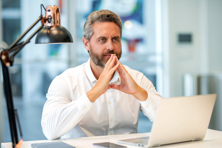 Office manager boss. Business boss in suit. Big boss. Businessman office worker laptop. Businessman in business office. Business success. Successful business man in office. Reading business reportの写真素材