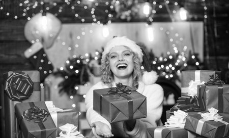 Beautiful wrapped gifts. December happy moments. Happy woman and bunch of gifts boxes. Girl ready for celebration. Gifts integral part of new year celebration. Xmas concept. Festive mood. Gift shopの写真素材