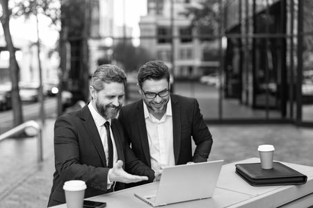 Freelancer developer do business online outdoor. Excited businessmen. Freelance business success. Freelance online. Successful businessmen freelance online. Businessmen freelancing in New Yorkの写真素材