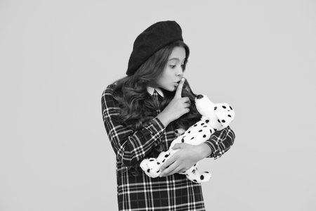 Childhood happiness. School girl in uniform play toy. Keep a secret. Teen girl back to school. Education in childhood. Student in uniform isolated on yellow. Hushの写真素材