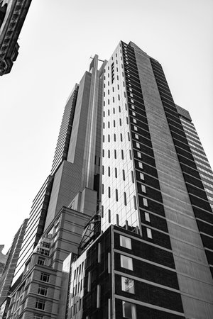 Skyscraper building architecture. Skyscraper with glassy facade. Modern glass building. Skyscraper in metropolis city. City downtown with skyscraper. Office building in business districtの写真素材