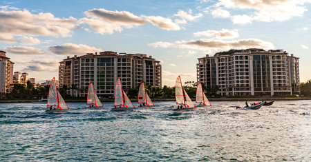 Fisher island building. Sailing boat yacht. Yachting in Miami. Boating and yachting. Sport lifestyle. Vacations on summer. Regatta sailing. Ocean sport. Yacht regatta at sea. Sea vacation on summerの写真素材