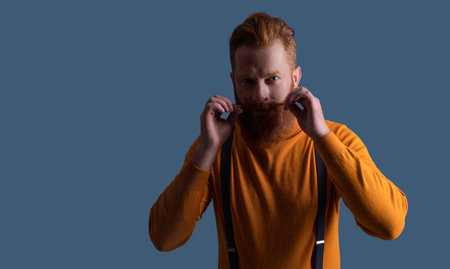 Vintage male fashion style. Male vintage style. Vintage guy wear retro suspenders. Retro man in suspenders isolated on grey. Mature redhead man with hairstyle. New style bannerの写真素材