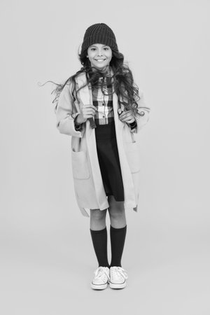 School education. Student in autumn style cloth. Stylish girl isolated on yellow. September 1. Study in college. Student girl carry backpack. Back to school. Knowledge day. Knowledge and educationの写真素材