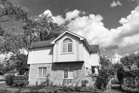 Property in neighborhood. Residential neighborhood house in developed area. Property insurance and real estate. Suburban neighborhood. Private property house. House insurance. Private lifeの写真素材