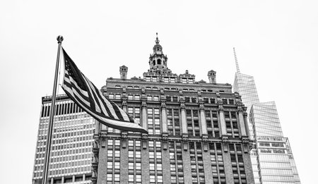 American flag at modern building in metropolis city. Business building skyscraper in city. City downtown with skyscraper. Architecture. Skyscraper building architecture. American flag, copy spaceの写真素材