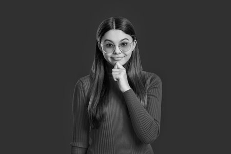 Stylish fashion portrait of trendy girl. Teen girl isolated on white. Teen girl wearing stylish casual sunglasses. Casual thinking girl fashion model in sunglasses. Trendy carefree teenagerの写真素材