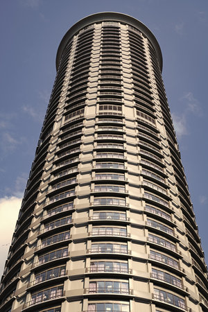 Tower building with skyscraper architecture. Skyscraper hotel in shape of tower. Modern city. Hotel...