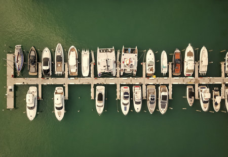Private boat top view. Marina with luxury sea boat. Yacht club and marina in Miami. Luxury marina with private yacht boat. Docked yacht boat in harbor. Luxury summer vacation in Miami. Marina harborの写真素材