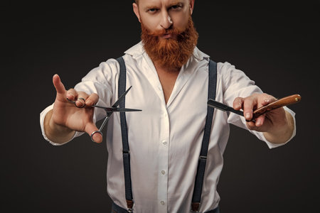 Haircut by hairdresser at barbershop. Barber man. Man barber with razor blade do haircut. Man barber making a haircut in a barbershop. Great time at barbershop. Luxury salonの写真素材