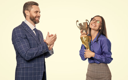 Business success. Two businesspeople on business successful meeting isolated on white. Successful business woman man in suit hold champion cup. Business reward and success. Express congratsの写真素材